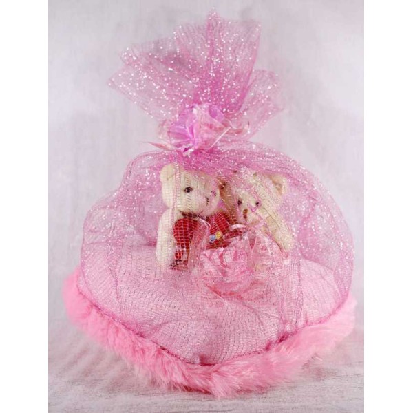 Valentine Couple Teddy Bears sitting on a pink plush heart covered with net